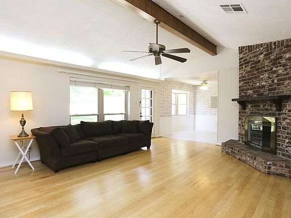 DEN [15x9] Enjoy the recently refinished hardwood flooring and the cozy gas/log fireplace. This room with a high ceiling is a perfect family retreat.