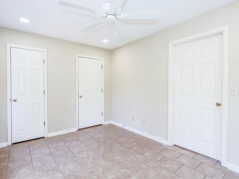 Another view of bedroom, showing door to closet (left), bath (middle) and living room (right).