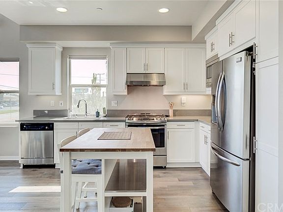 Kitchen with soft close drawers, stainless steel appliances, quartz countertops, and shaker cabinets.