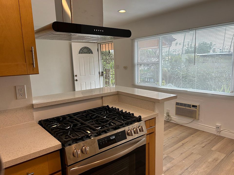Bright and airy upper unit view from kitchen of front door, living room, dining room and neighborhood.