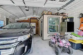 Attached garage with an air conditioned work room used as a craft room.