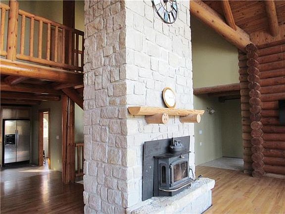 Floor to ceiling limestone fireplace.