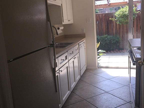 Kitchen to patio deck; full sized refrigerator