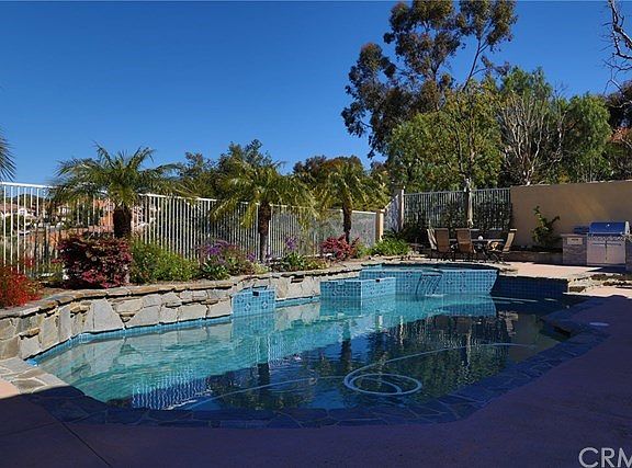 A photo of the beautiful pool with spa and waterfalls, also a place for patio furniture next to the 