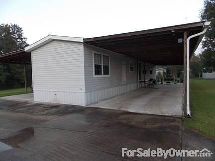 Exterior View from Road : All windows and Exterior Doors have been replaced. Vinyl siding and metal 