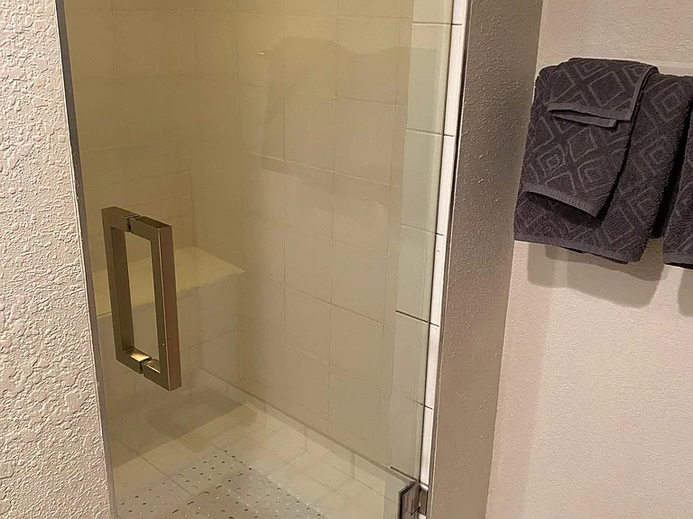 Updated bathroom with new shower door, cleaned grout and paint