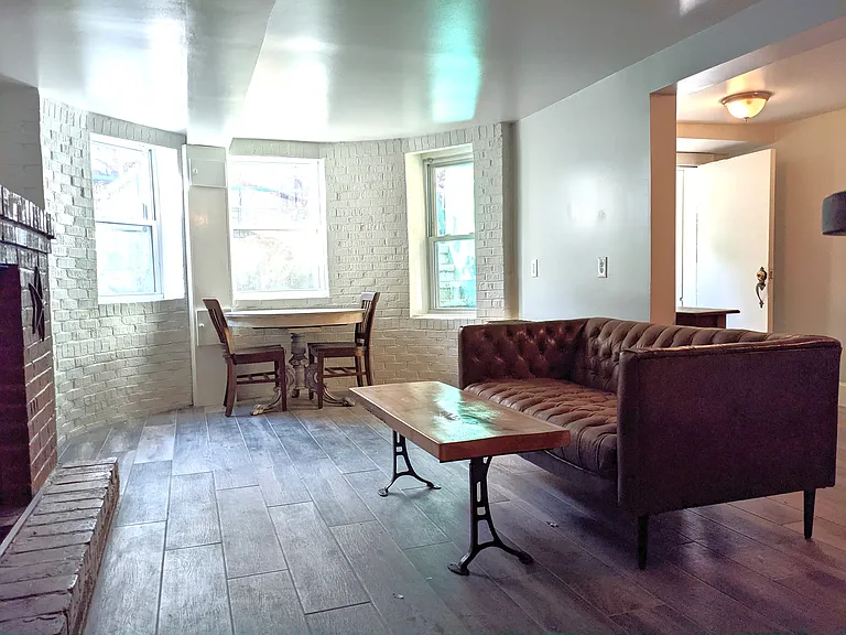 Living room from hallway to bedroom. Front door to the right.