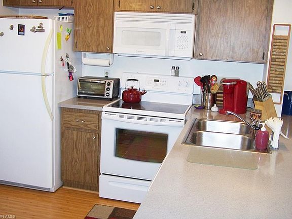 Another view shows the well maintained kitchen appliances, cabinetry and easily maintained bamboo laminate flooring.