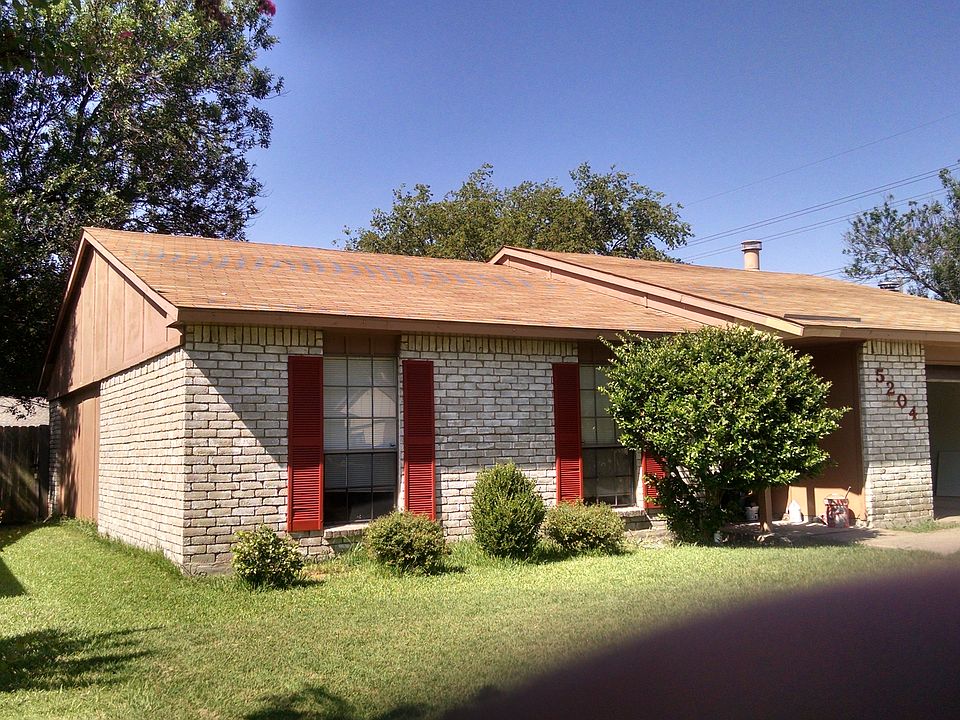 Front of house with open garage