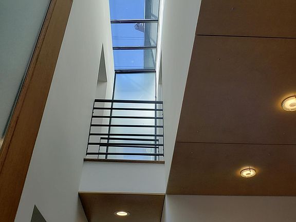 Atrium. Light from skylights streams through all 3 levels.