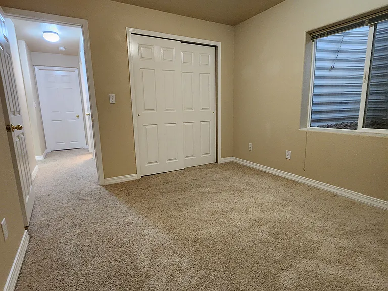 Downstairs Bedroom #2 - Looking down the hallway at the door to Bedroom #1