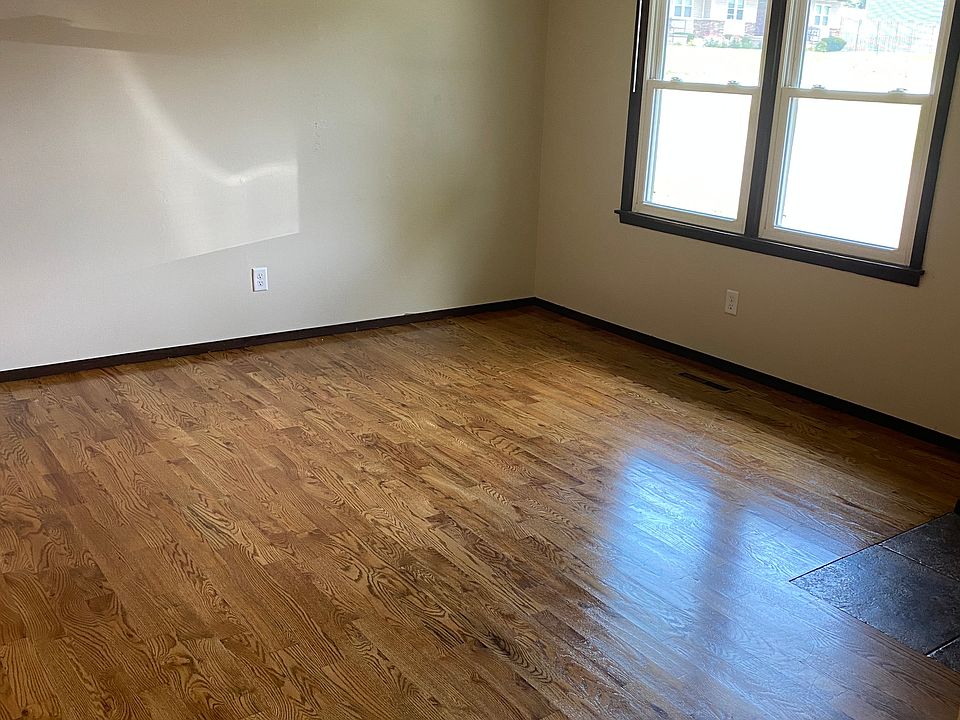 Spacious front room with hard wood flooring.