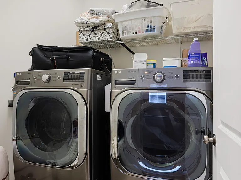 Upper level laundry with full size washer/dryer and pedestals.