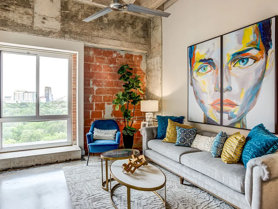 Historic loft interiors with exposed brick and natural light at Hermann Park Lofts.