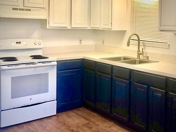Kitchen: navy lower cabinets, white upper, upgraded gold faucet.