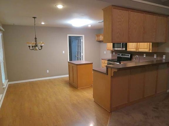 Open kitchen with stainless appliances.