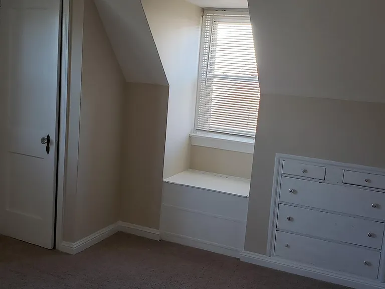 Middle bedroom with built-in dresser in the wall, (lift up) window seat & closet
