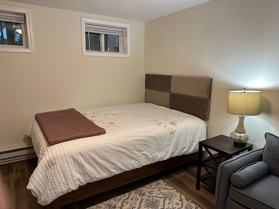Queen bed with luxury mattress, new linens, and plush headboard. Windows pictured are brand new.