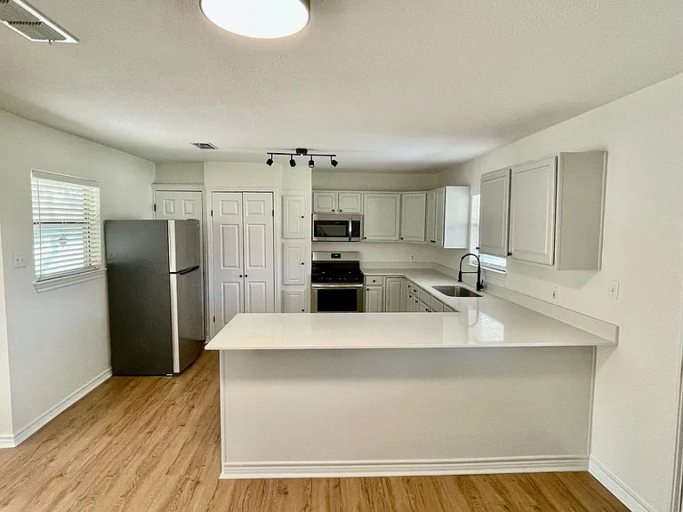 Kitchen with view of new refrigerator