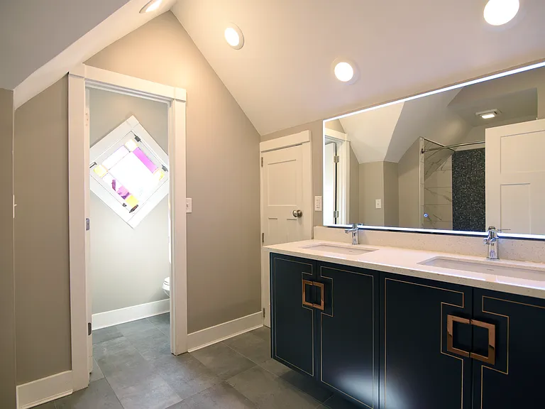 Lighted mirror enhances the space and it is a well appointed feature.