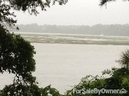 Colleton River at High Tide
						:
						Water seems to stretch for miles as it fills the marsh across the river