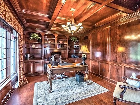 This handsome den is to the left of the foyer through french doors.