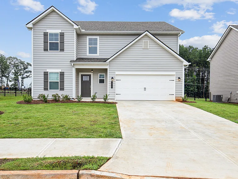 Exterior of the Hastings, two story home with a private driveway and attached garage.