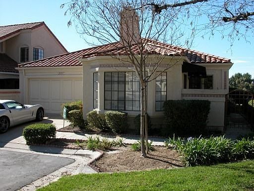 Front View with Gated Entry Way and Lawn