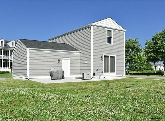 Large patio for entertaining with a service door to the garage.