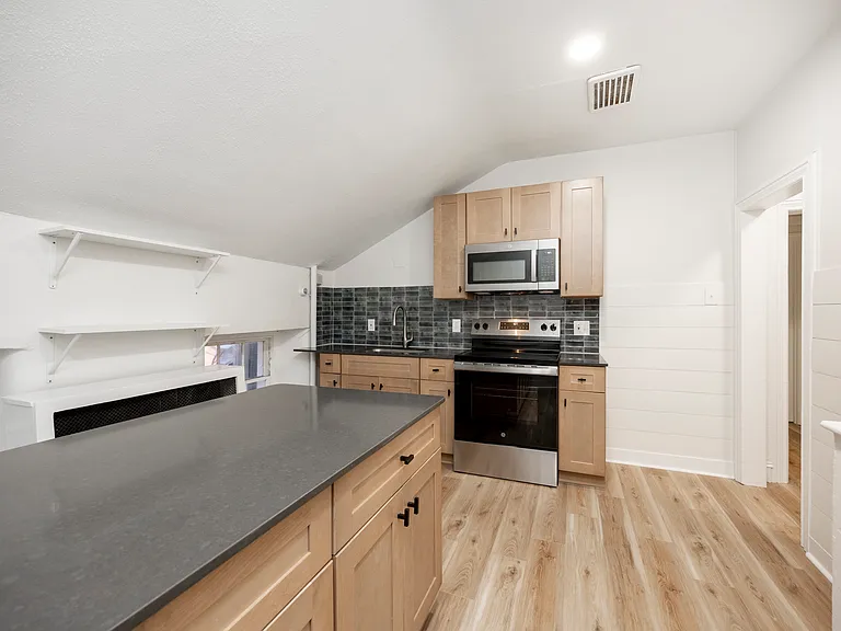 kitchen with island, OTR microwave, smooth top stove