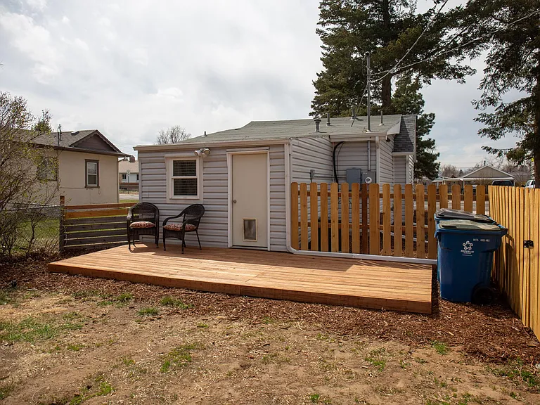Fully fenced backyard with a brand new deck. Back door leading into master bedroom.