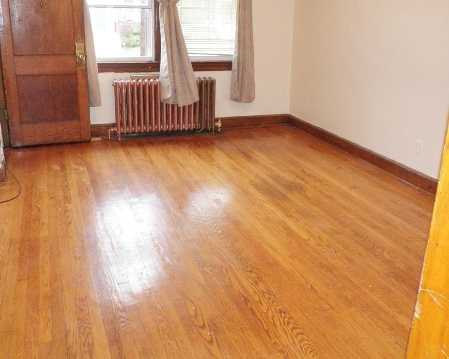 Beautiful hardwood floors in living room with sunlight