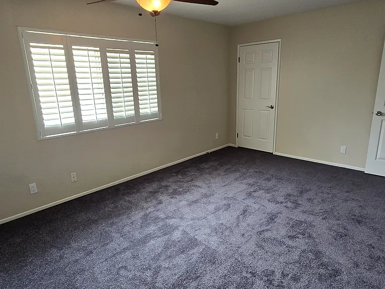 Master bedroom features two closets and ceiling fan
