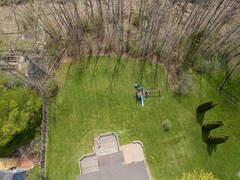 Large private yard is tree lined and backs up to a gold course