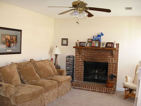 Brick, wood burning fireplace graces living room!