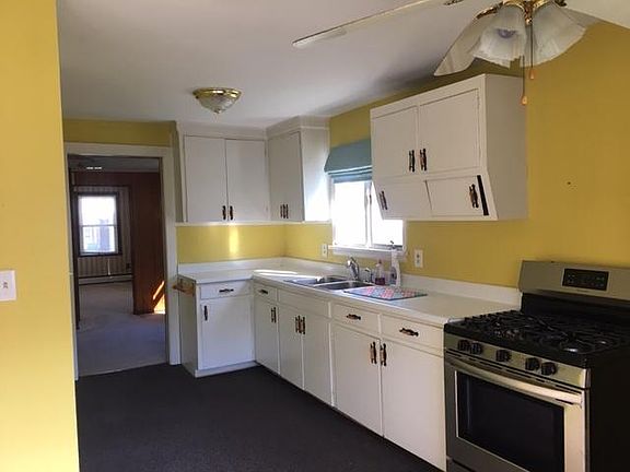 Kitchen has gas stove and refrigerator; ample storage space