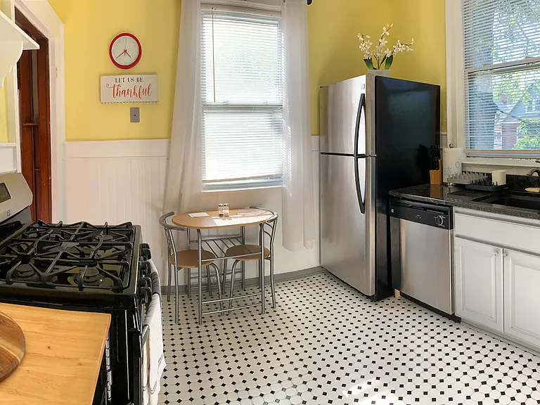 [Kitchen] Two large windows with a view of the backyard.