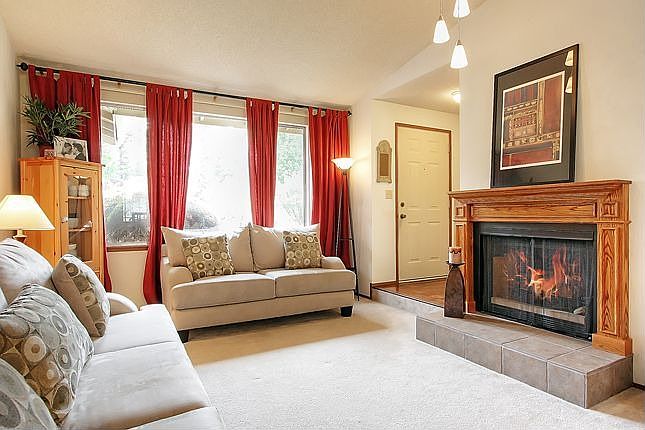 Formal Living Room has woodburning fireplace with custom mantel.