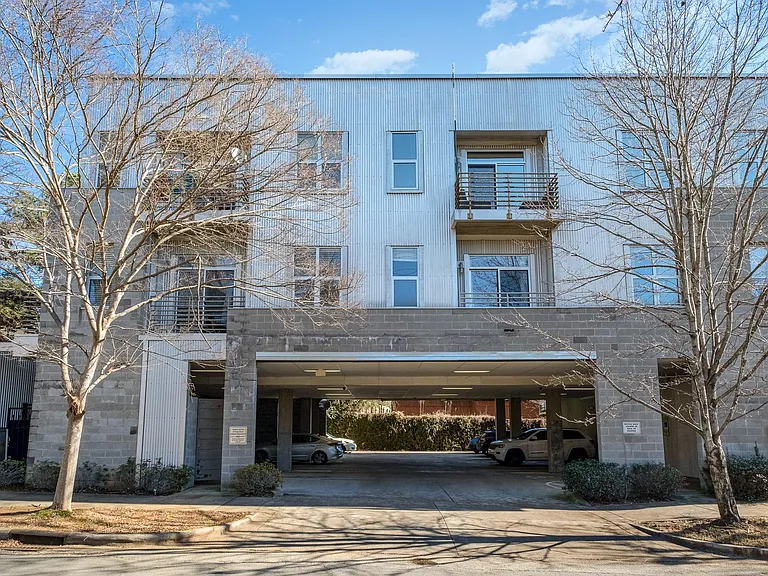 View of the condo from Fulton Ave, showing the small parking garage below. You would have designated parking spot in the garage, and then there is plenty of very close street parking outside.