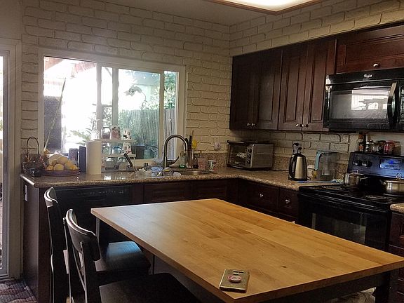 Updated kitchen with oven range, microwave, dishwasher, Kitchen sink with pull-down, sprayhead faucet.