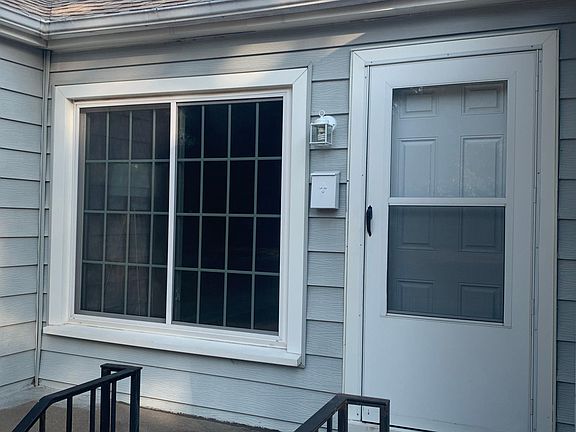 Close up of the exterior with newer siding, windows and storm doors