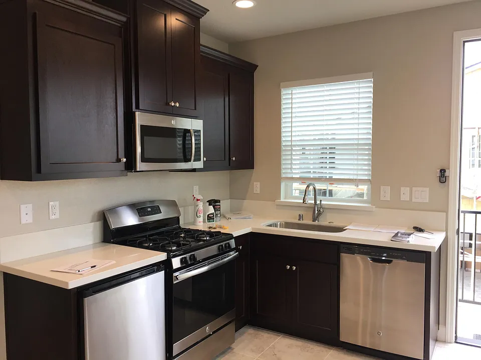 Kitchen with Gas stove & oven, microwave, small refrigerator and dishwasher.