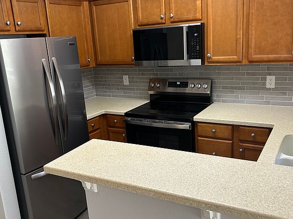 New stainless steel appliances in kitchen. New kitchen window and window covering. New backsplash in kitchen.