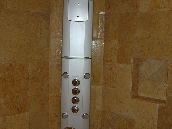 Large Custom Walk-In Shower with multiple heads and Bella Pietra Tile. 