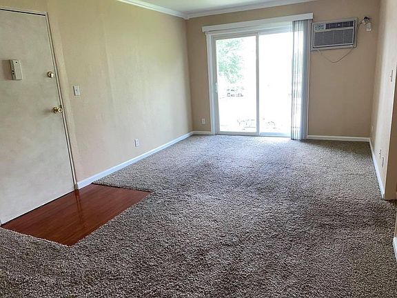 spacious living room with A/C unit