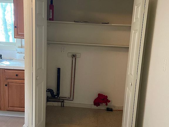 Laundry closet in Kitchen area.