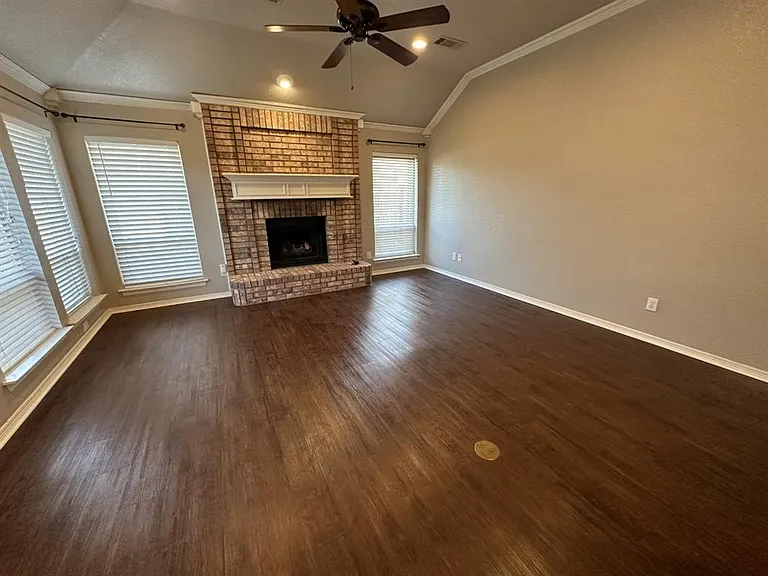 Warm and inviting main living area. Beautiful flooring and bricked fireplace with hearth.