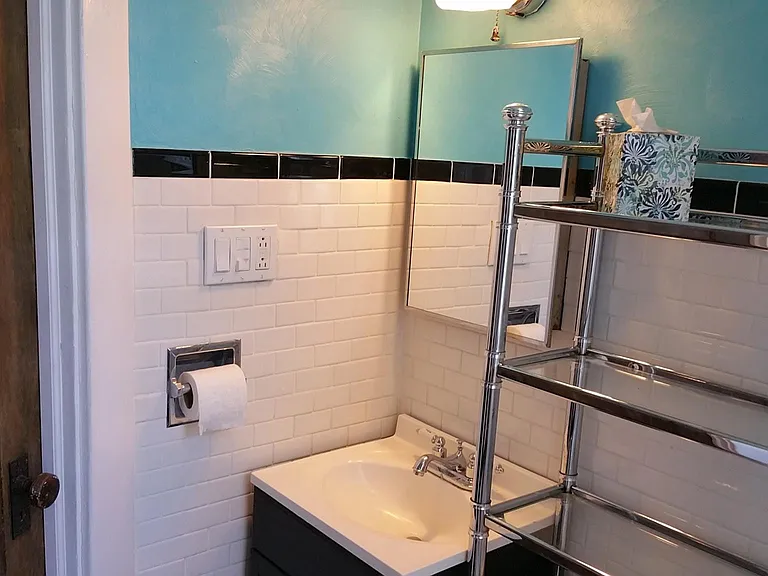 An old door brings in the original charm to the bright bathroom!