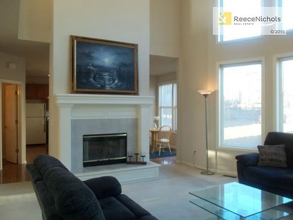 Spacious Living Room with Beautiful Fireplace and Windows!