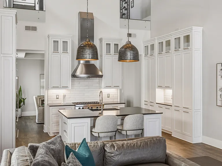 The chef's kitchen boasts a massive island, pantry wall, Wolf steam & convection ovens, a 6-burner 36" gas range and Sub-Zero refrigerator. Everything you need to cook at home, plus island seating and a dining table/room.